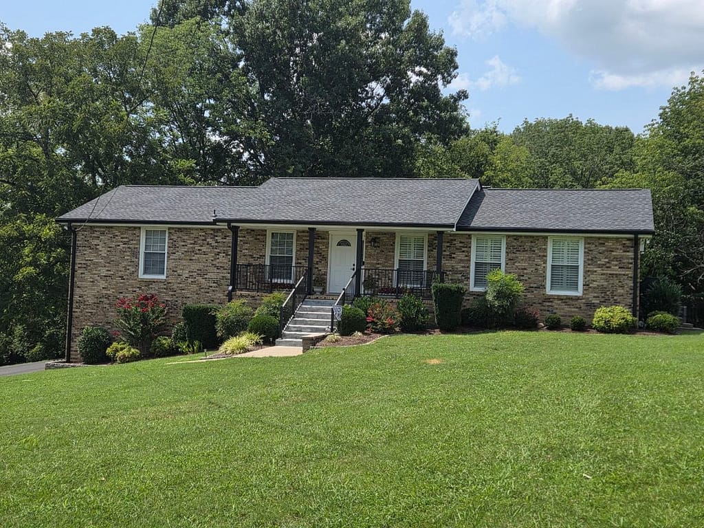 Middle Tennessee home with new shingle roof, siding, gutters, gutter guards, columns, guard rails and stair rails,